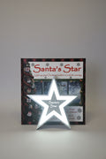 Santa's Star product packaging on a wooden surface with Christmas decorations.